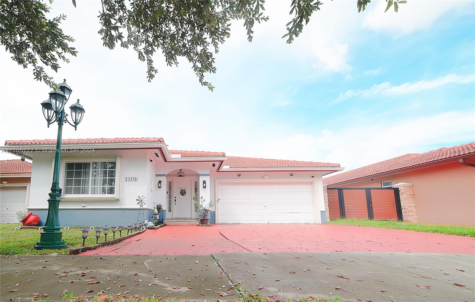 a view of a house with a yard and garage