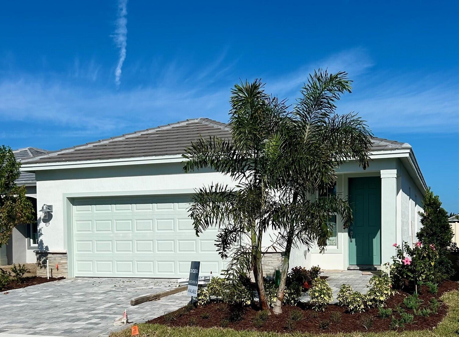 a front view of a house with plants