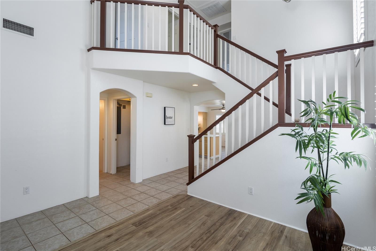 a view of staircase with wooden floor and a potted plant