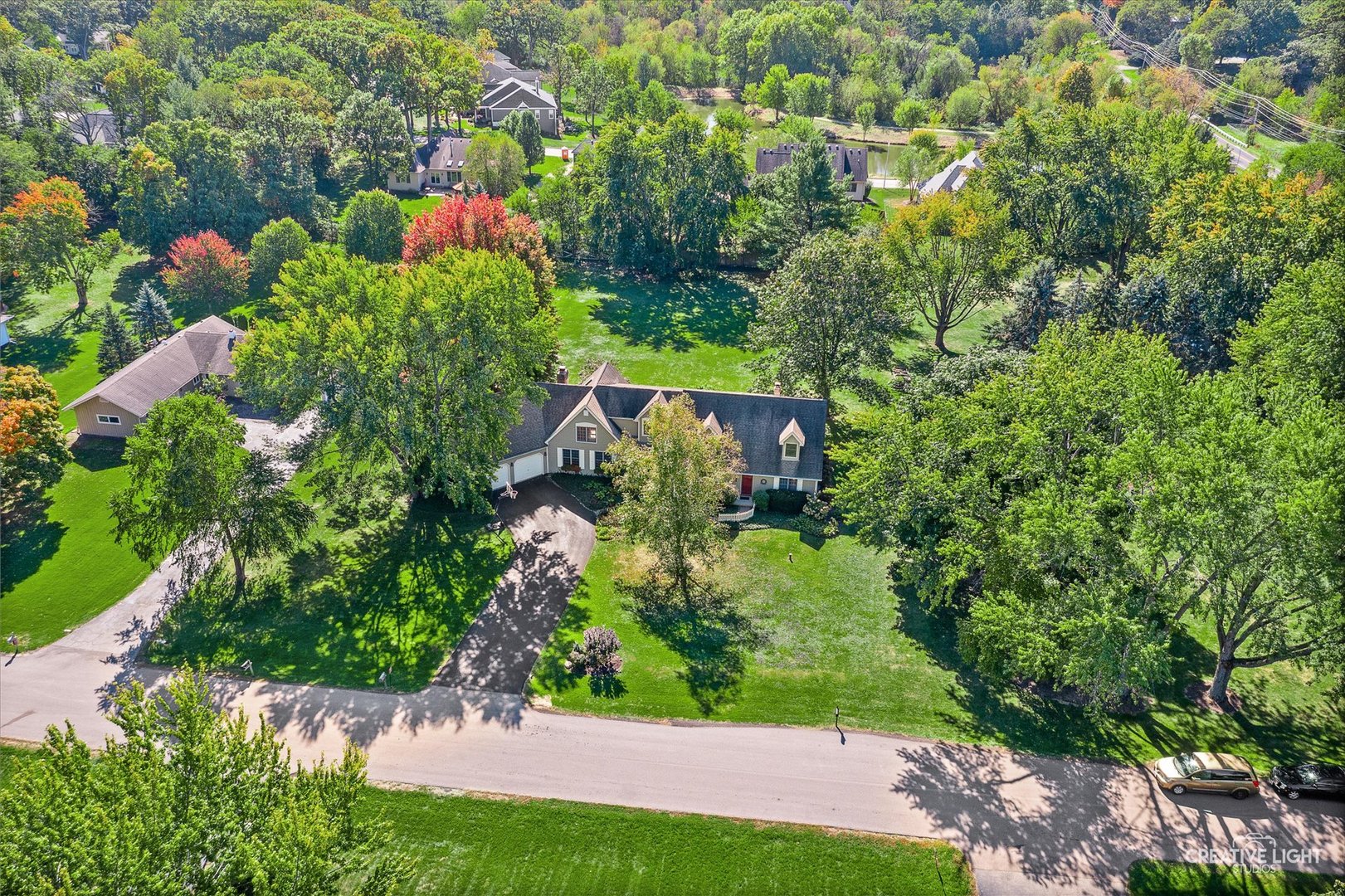 an aerial view of a house with a yard basket ball court and outdoor seating