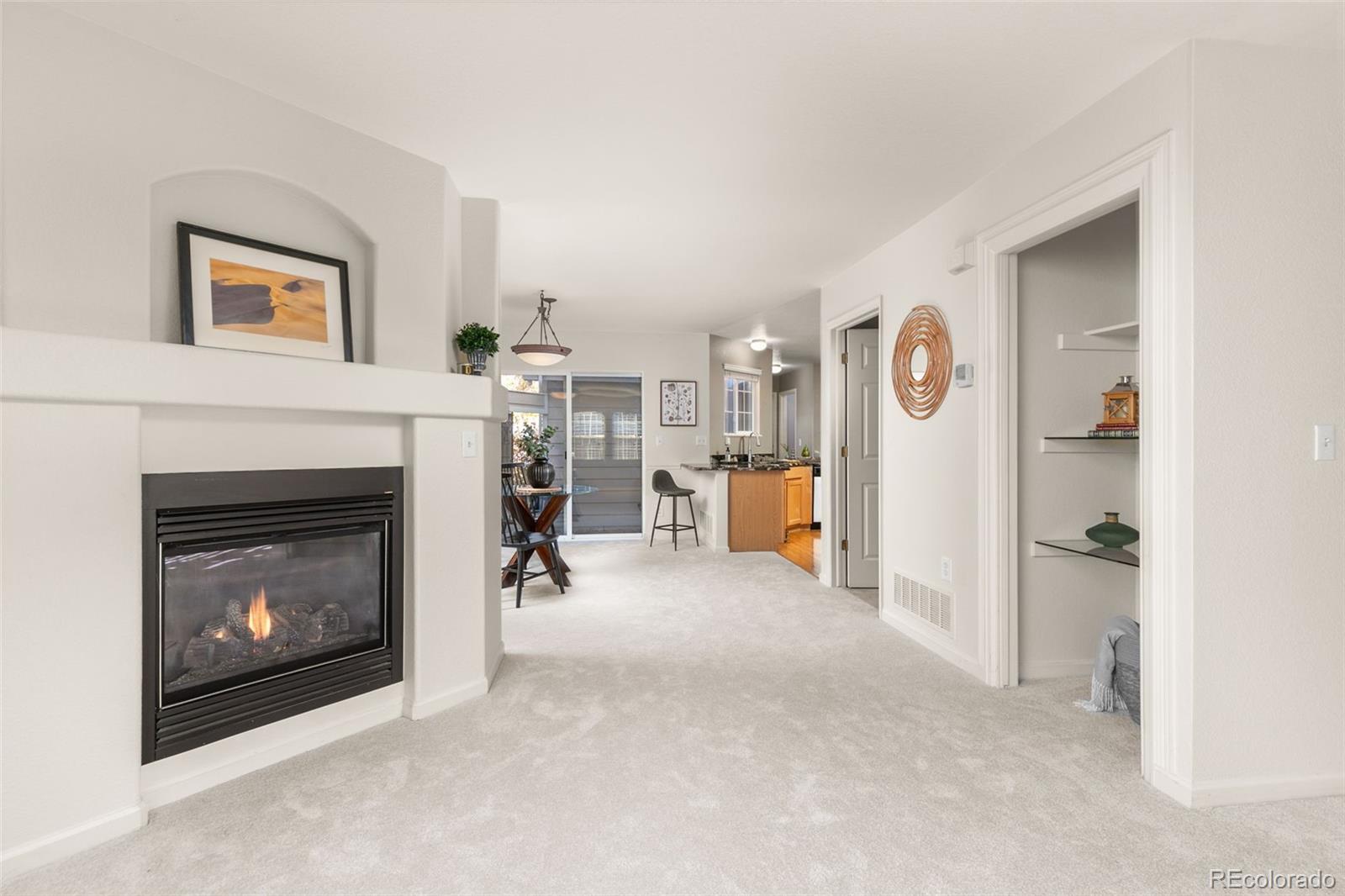 a view of a livingroom with a fireplace and workspace