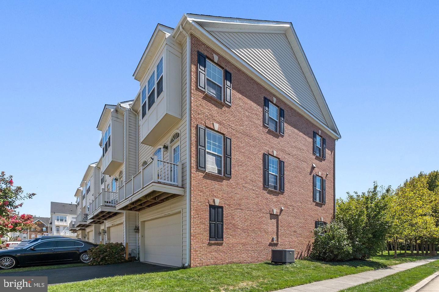 a view of a brick building next to a yard