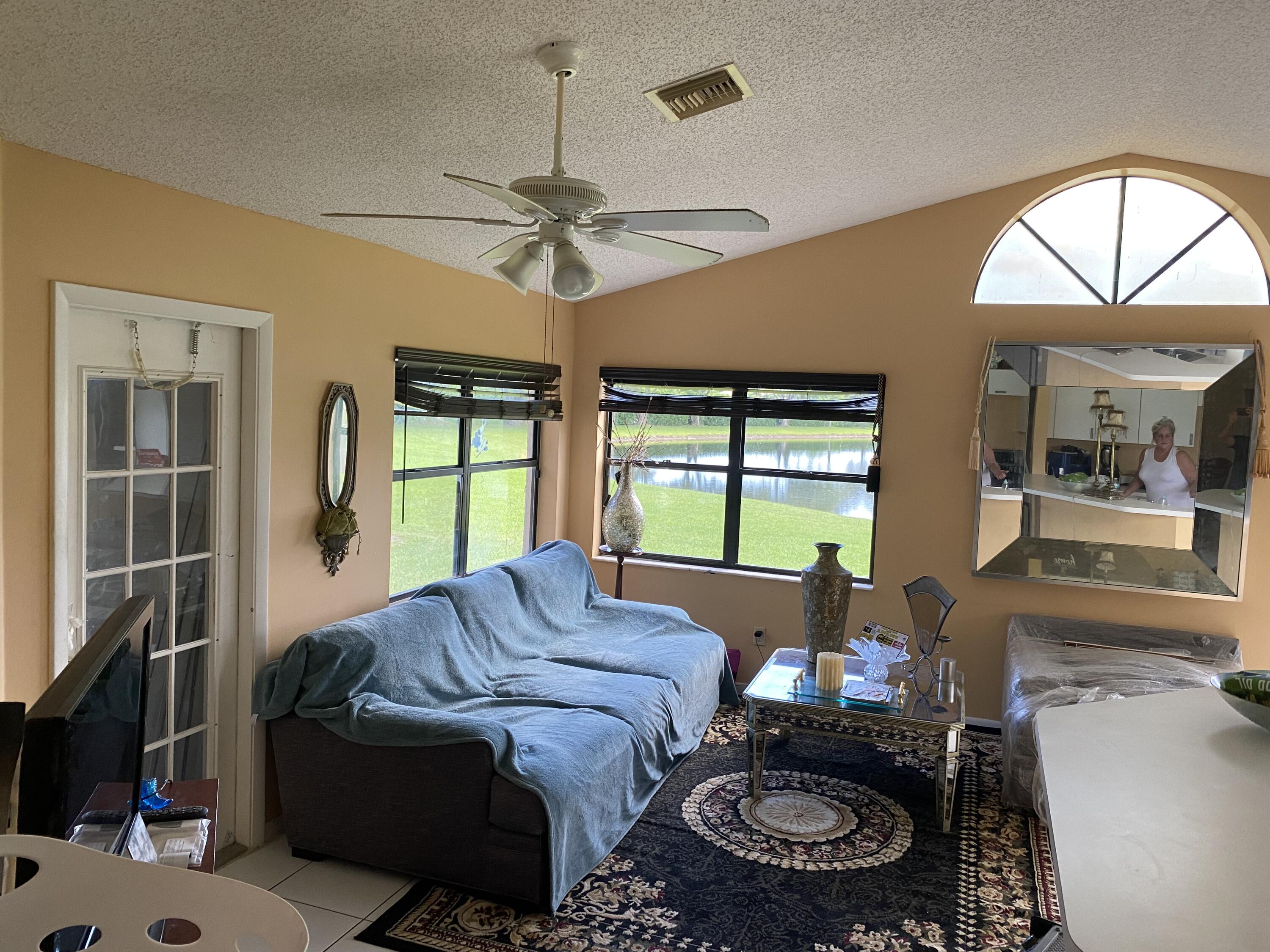 a living room with furniture a window and a chandelier