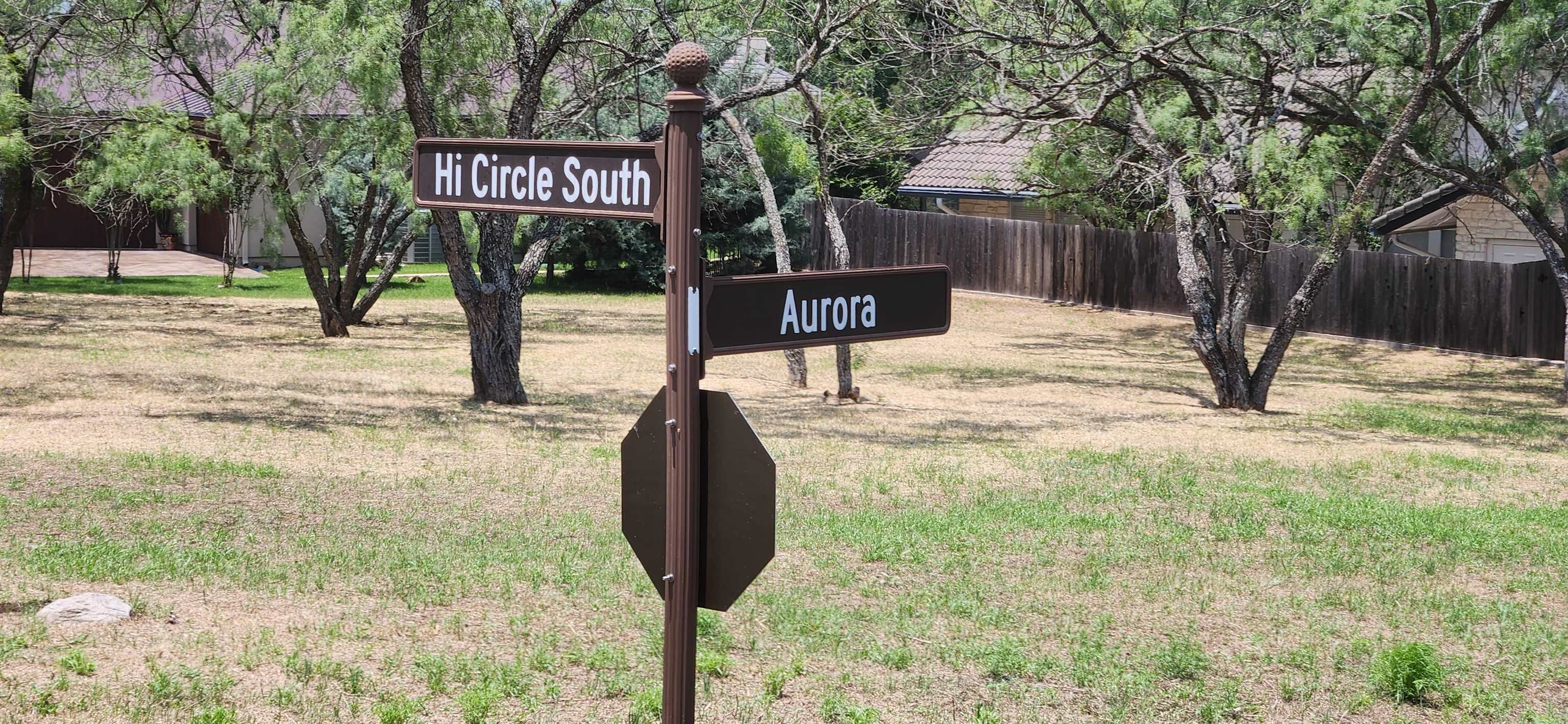 a street sign on a sidewalk next to a road