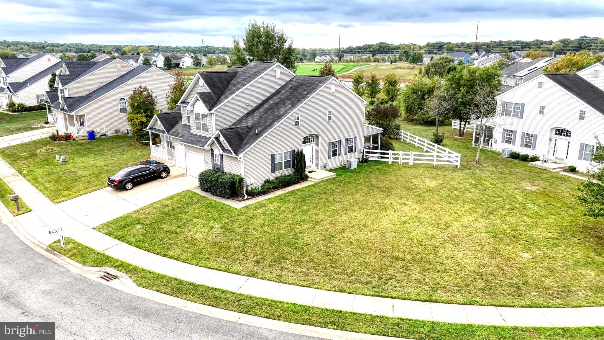 a view of a house with a big yard and large trees