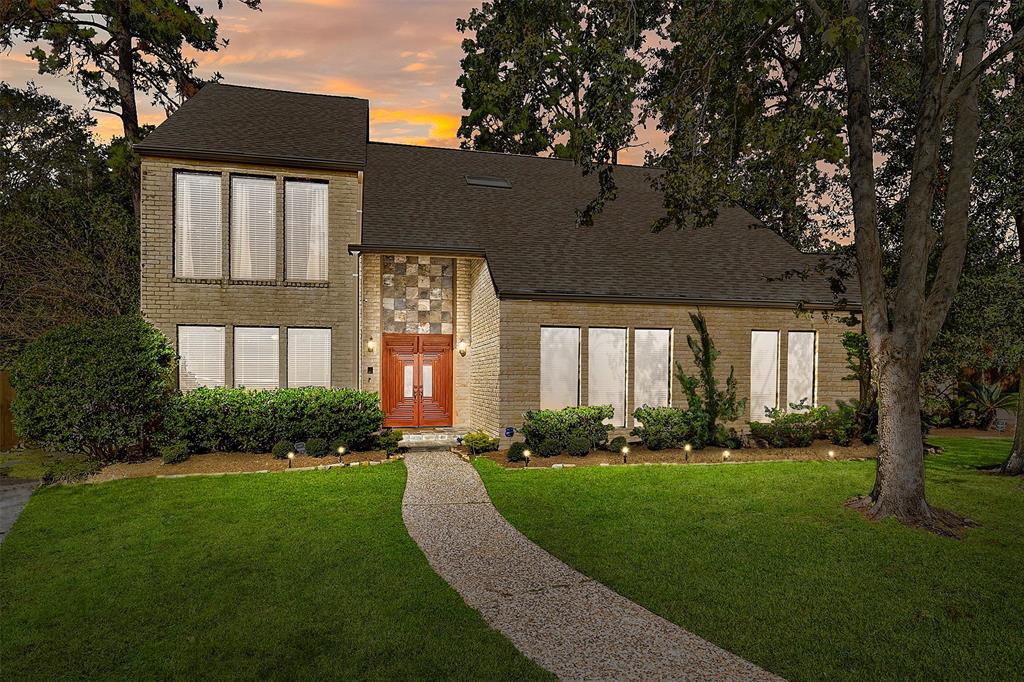 a front view of a house with a yard and outdoor seating