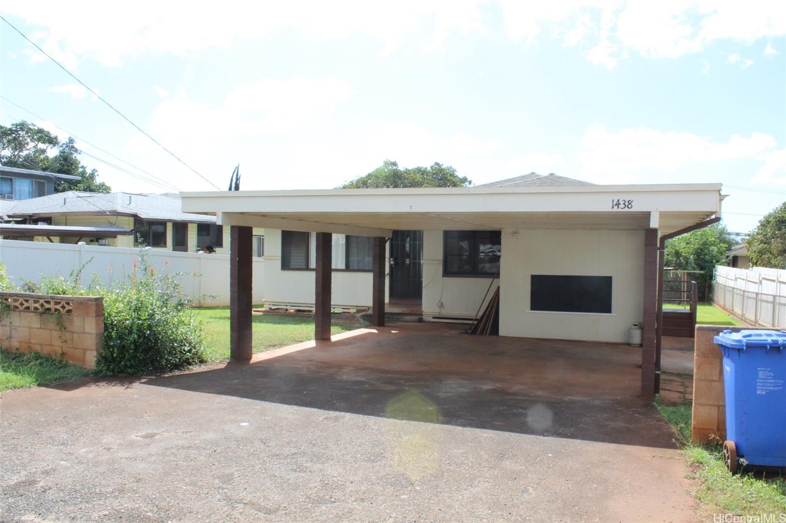 a front view of a house with a garden and yard