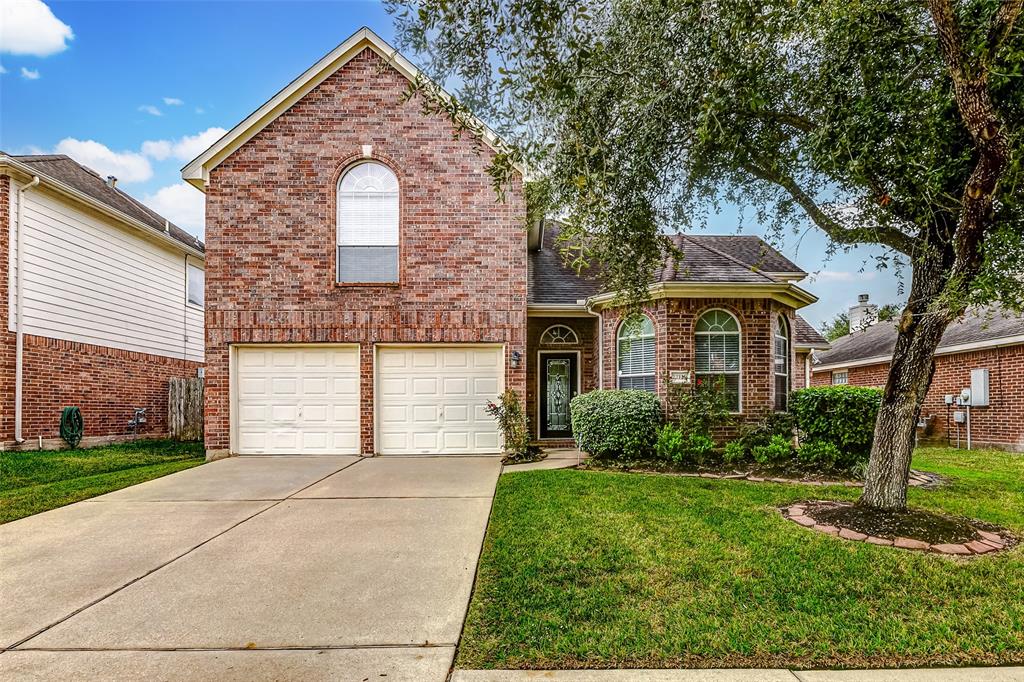 Inviting two-story with a classic brick exterior.