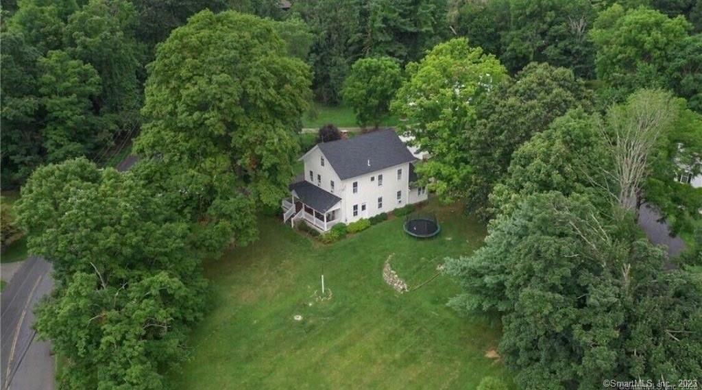 an aerial view of a house with a yard