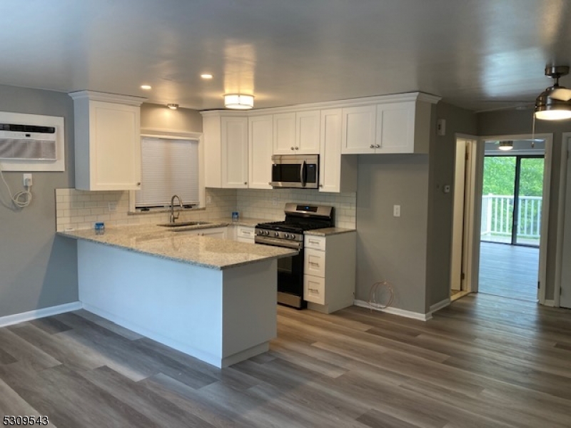 a kitchen with kitchen island a sink and a stove top oven