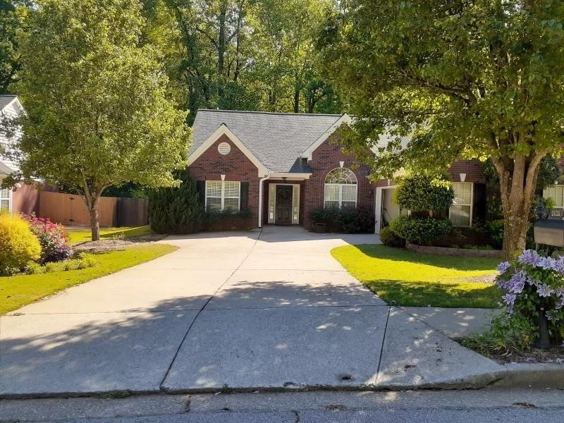 a house that has a big yard with large trees