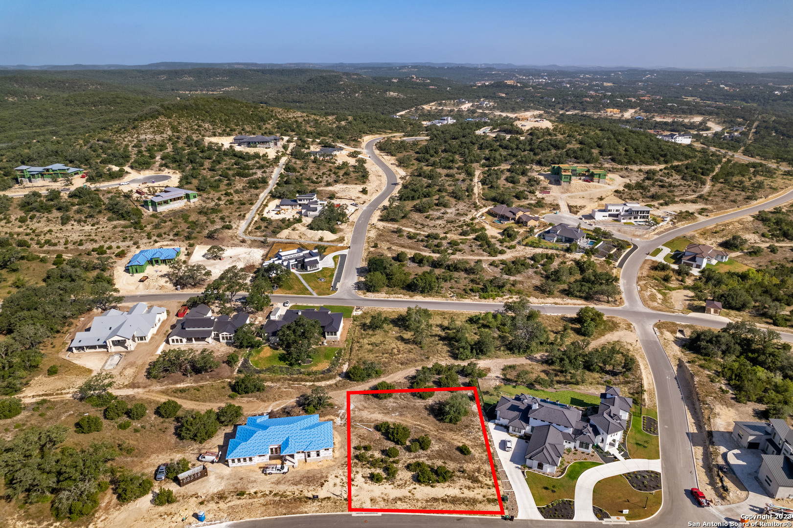 an aerial view of residential houses with outdoor space