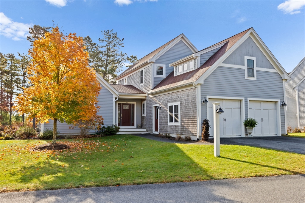 a front view of a house with a yard porch and seating area