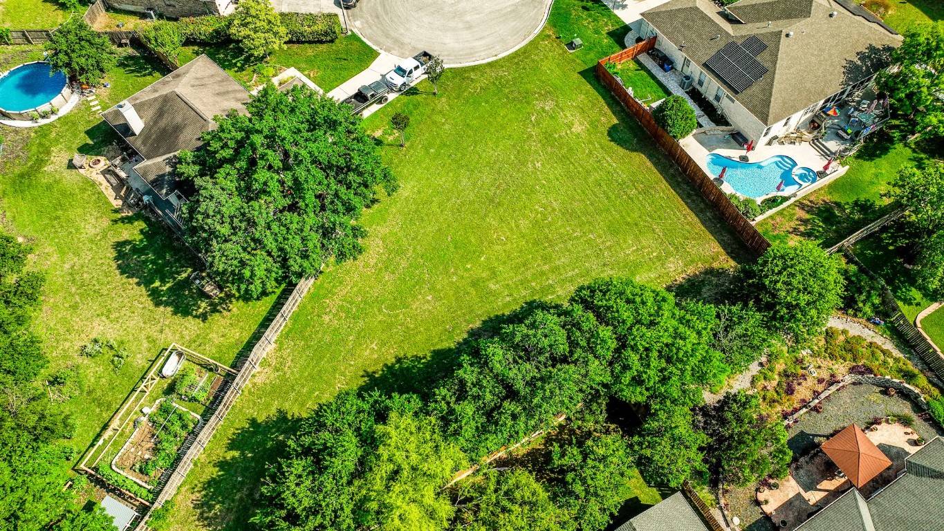 an aerial view of residential houses with yard