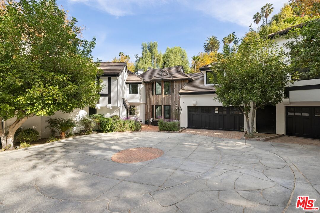 a front view of a house with a yard and a garage