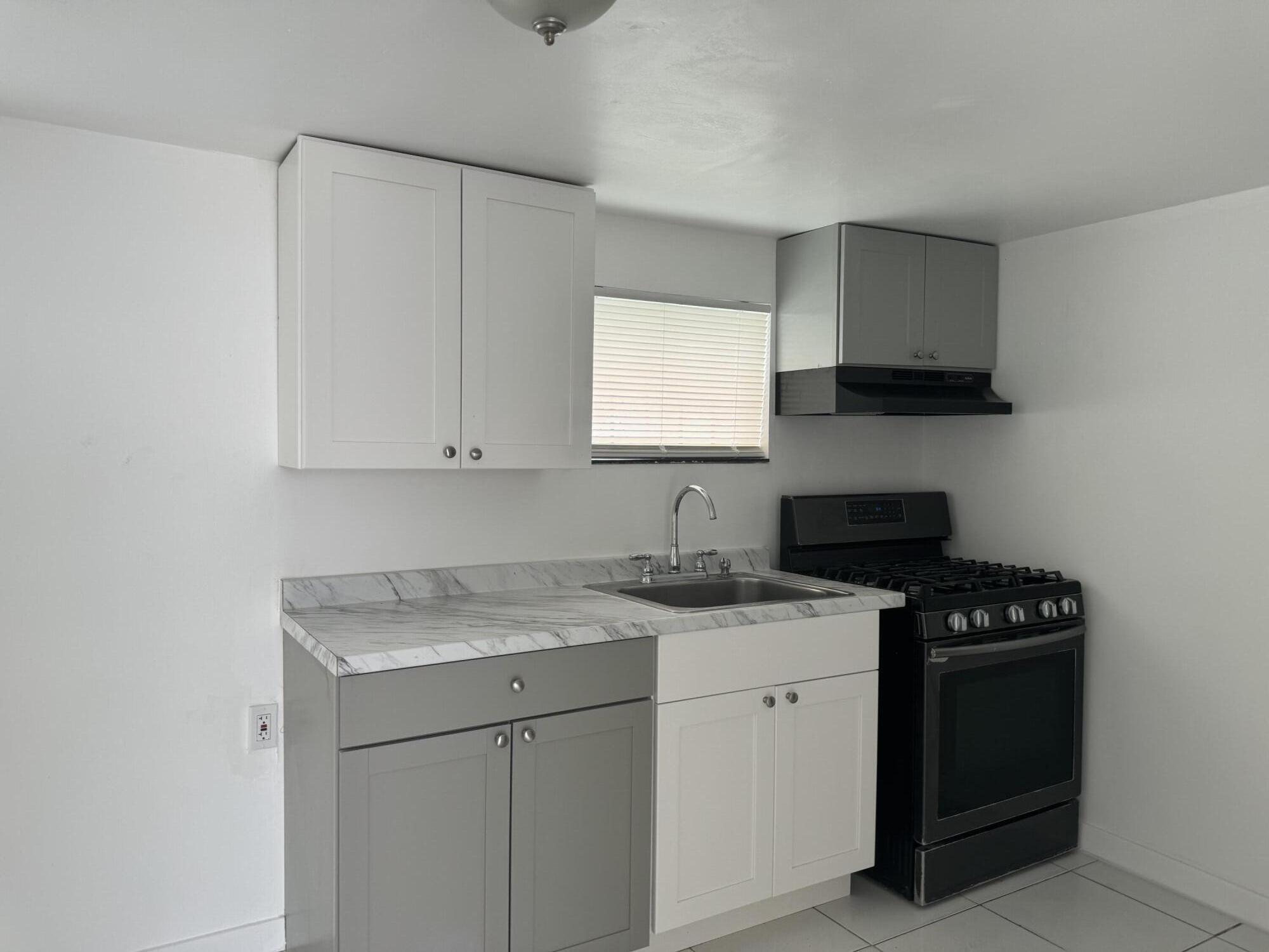 a kitchen with a sink stove and cabinets