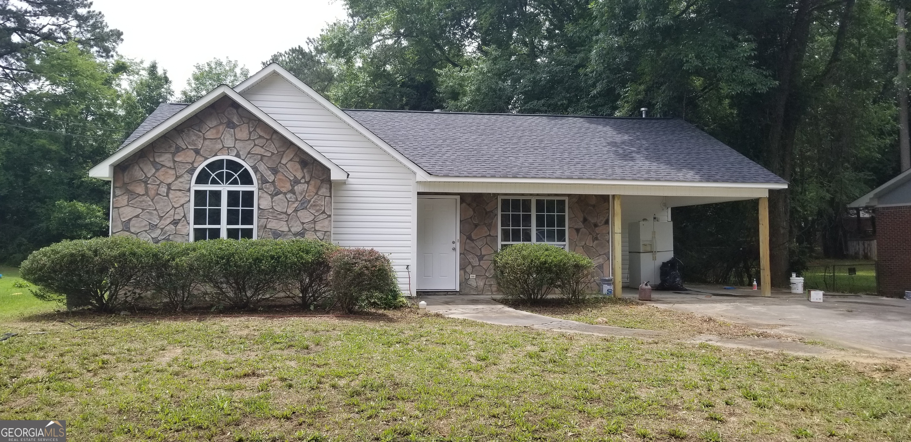 a front view of a house with a garden