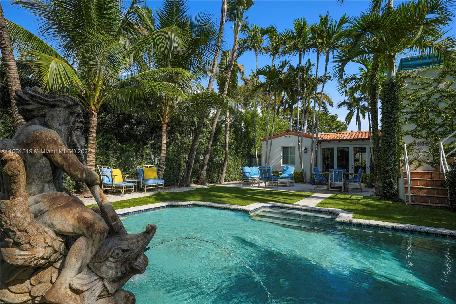 a front view of a house with swimming pool having outdoor seating