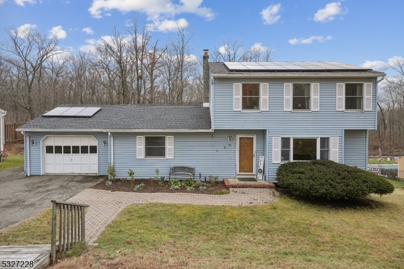 a front view of a house with yard and seating space