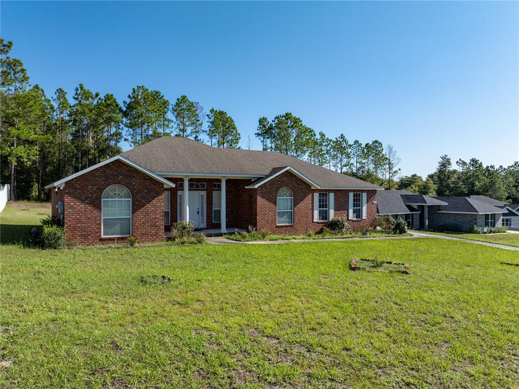 a house with huge green field in front of it