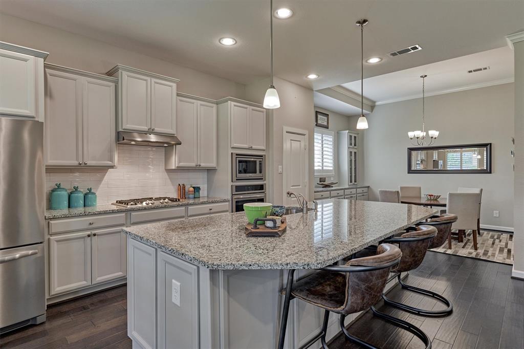 Welcome to the light and bright wide-open kitchen/living at 31771 Twin Timbers Ln.