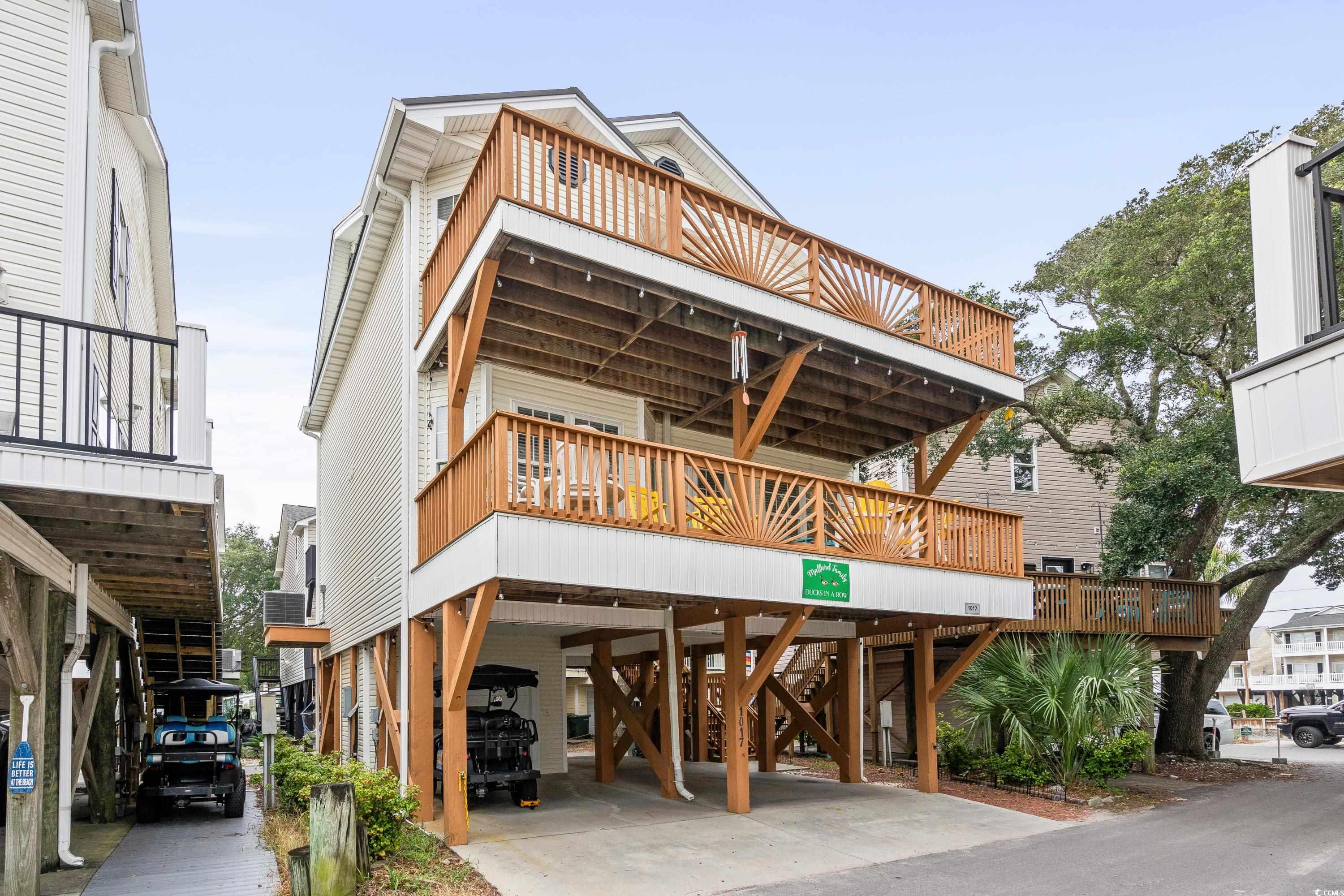 Exterior space featuring a balcony and a carport