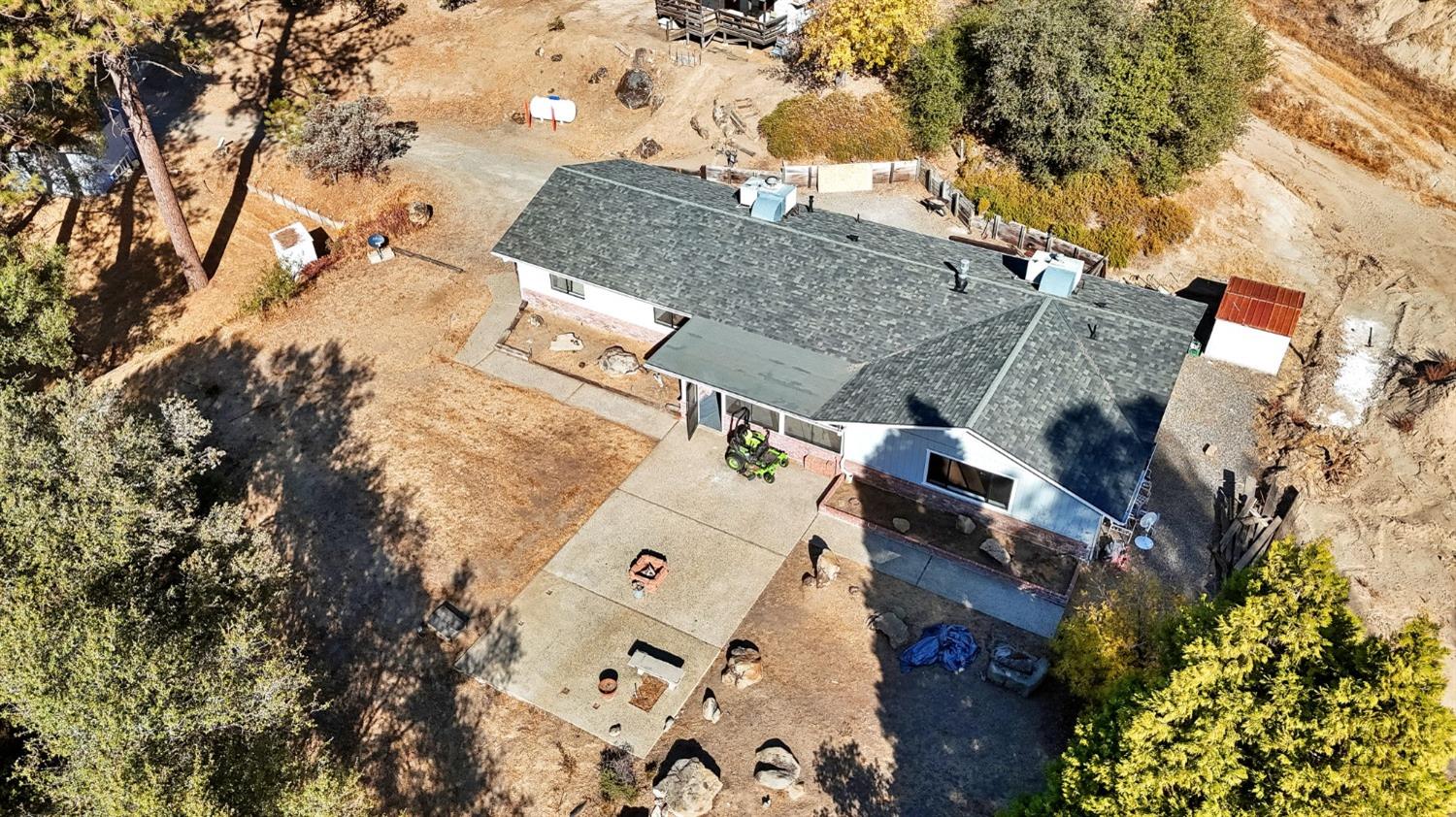 an aerial view of a house with a yard