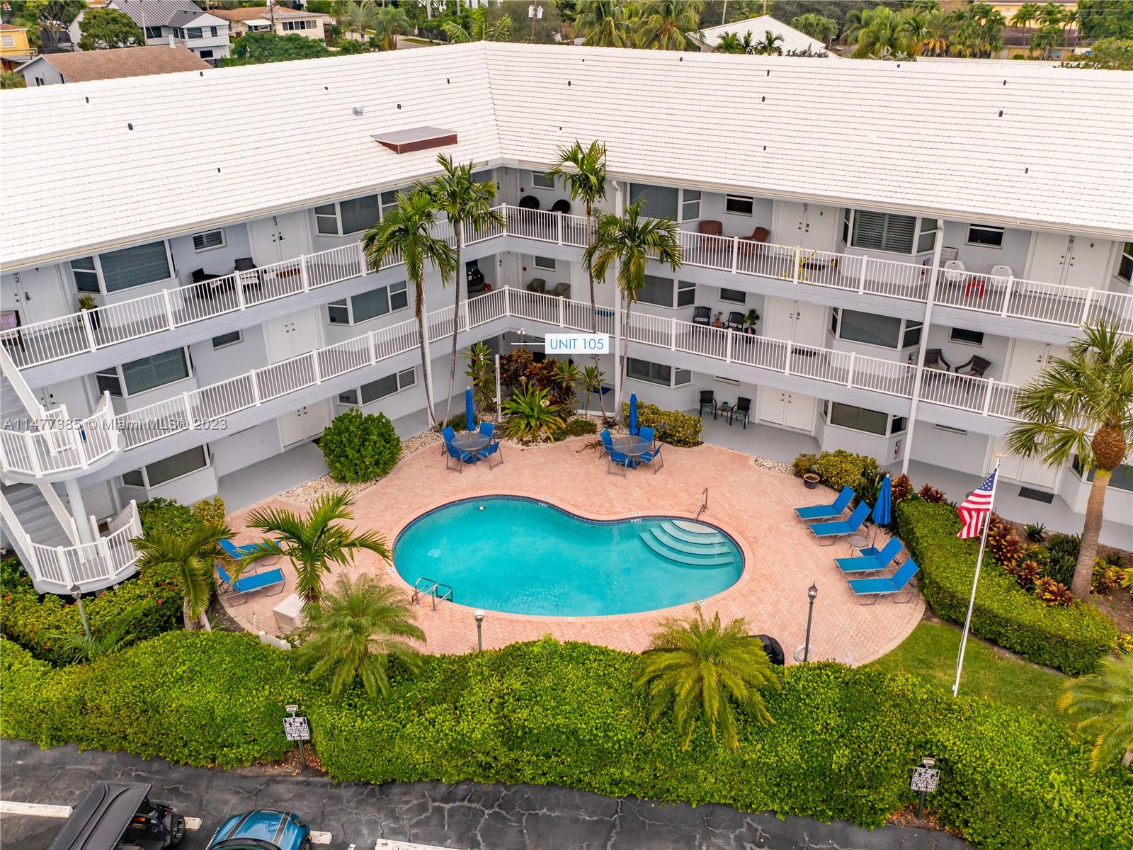 an aerial view of residential houses with outdoor space and parking