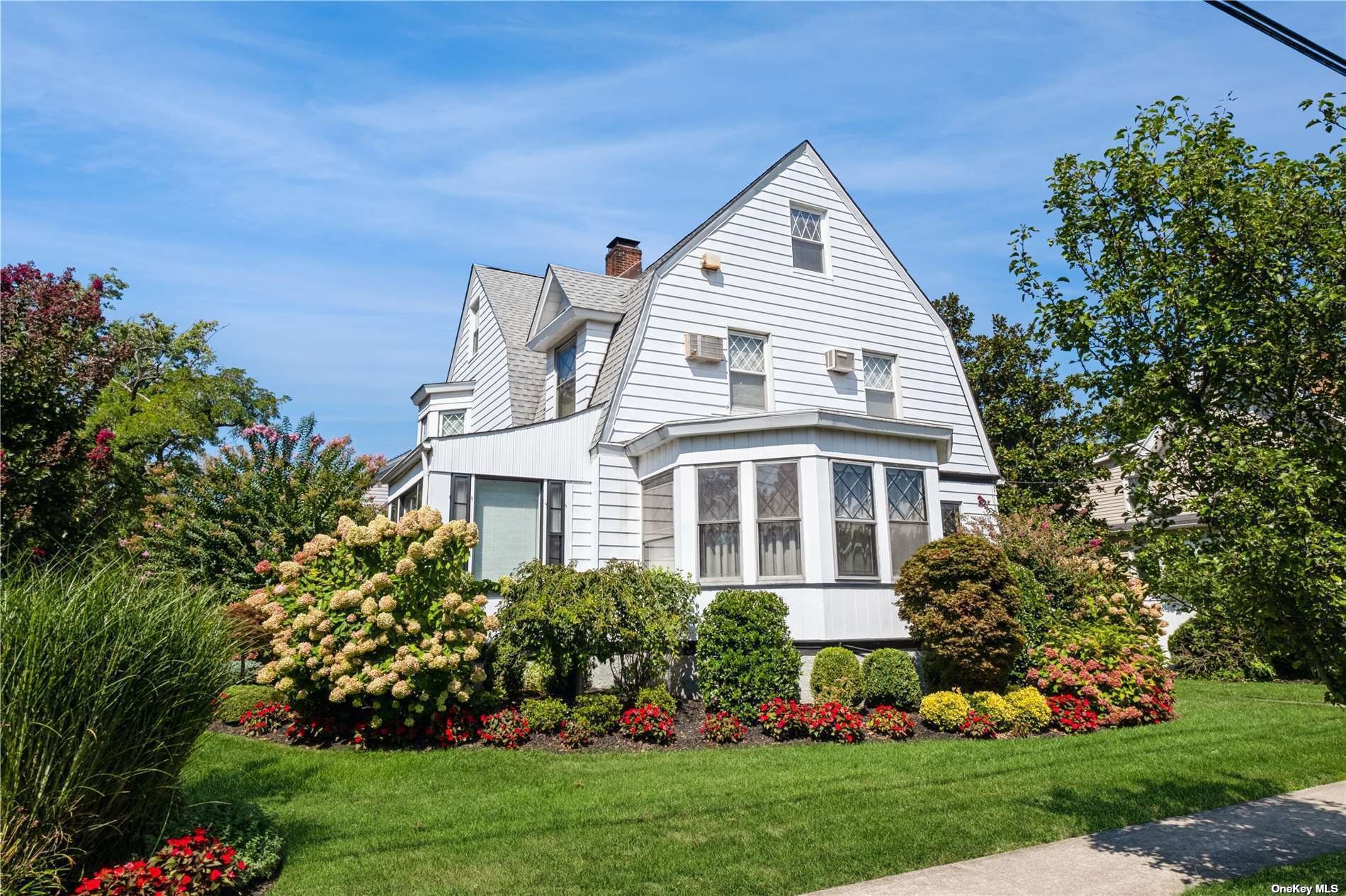 a front view of a house with a garden