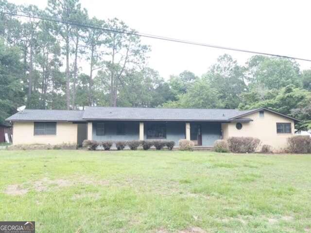 a house that has a tree in front of it