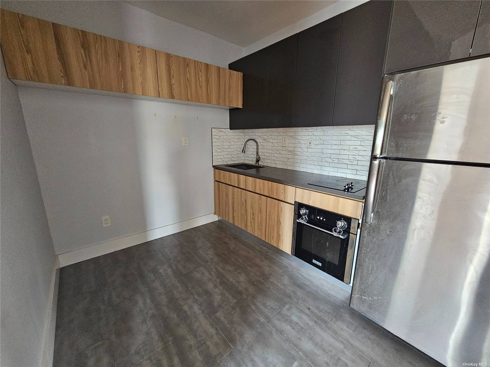 a kitchen with stainless steel appliances a refrigerator and a sink