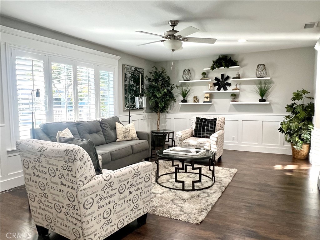 a living room with furniture a chandelier and a table