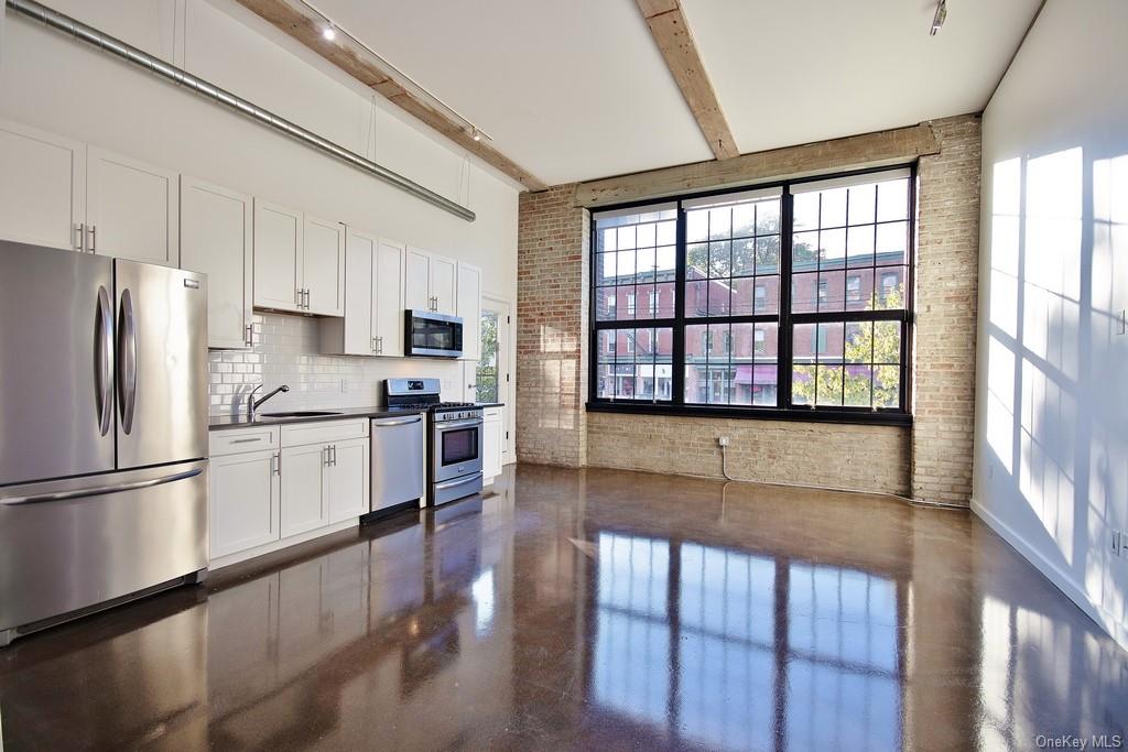 a kitchen with stainless steel appliances a refrigerator and a stove top oven