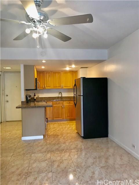 a view of a kitchen with a sink and a refrigerator