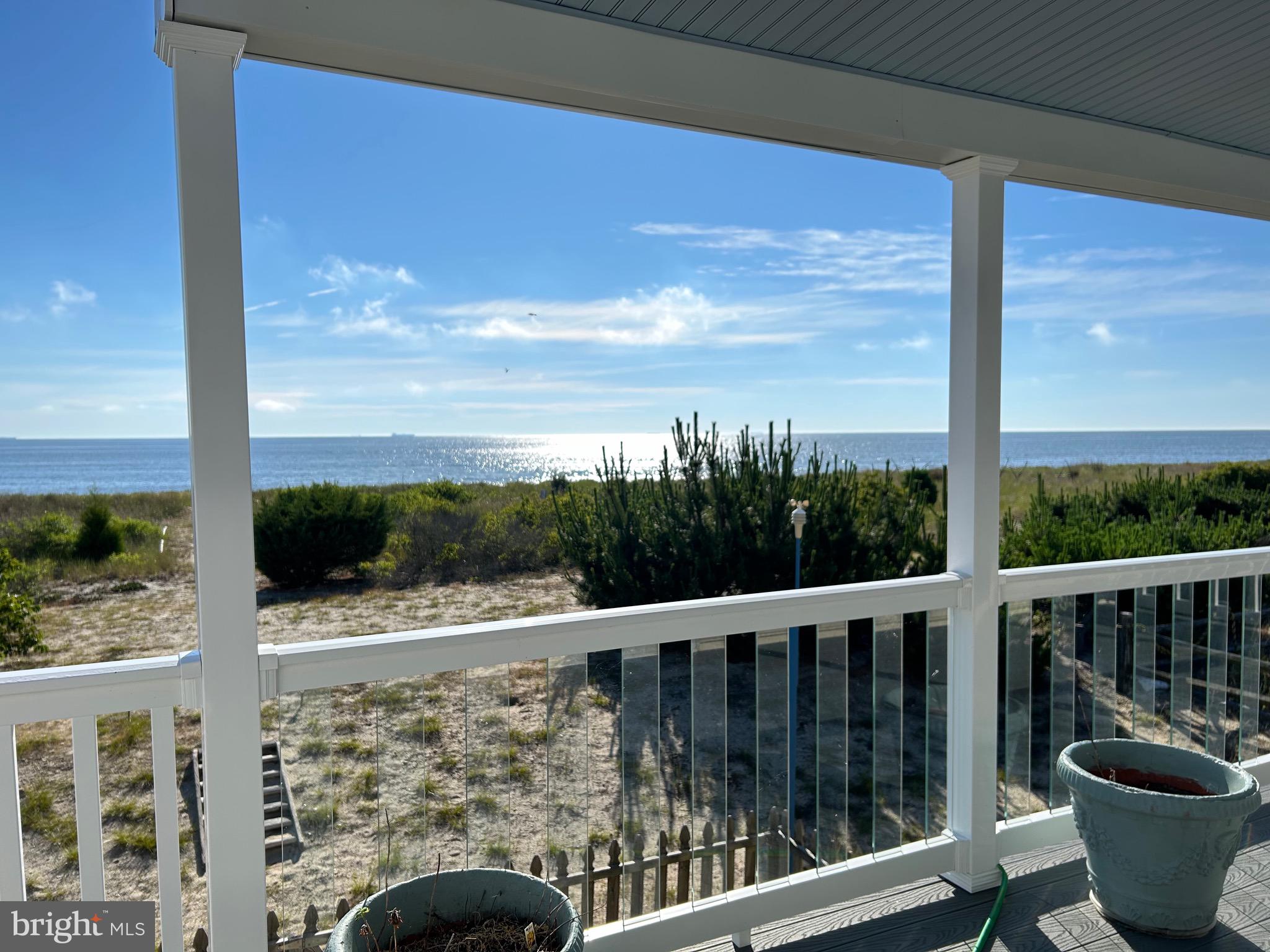 a view of a balcony with chair and wooden floor