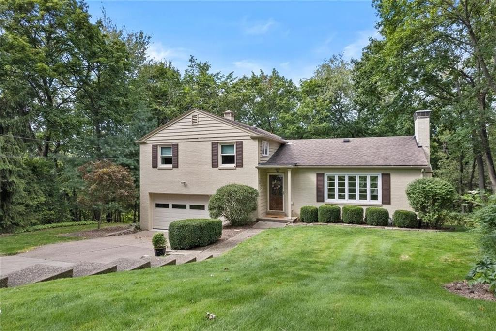 a front view of a house with a yard and outdoor seating