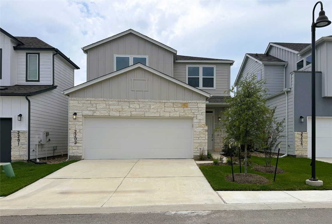 a front view of a house with a yard and garage