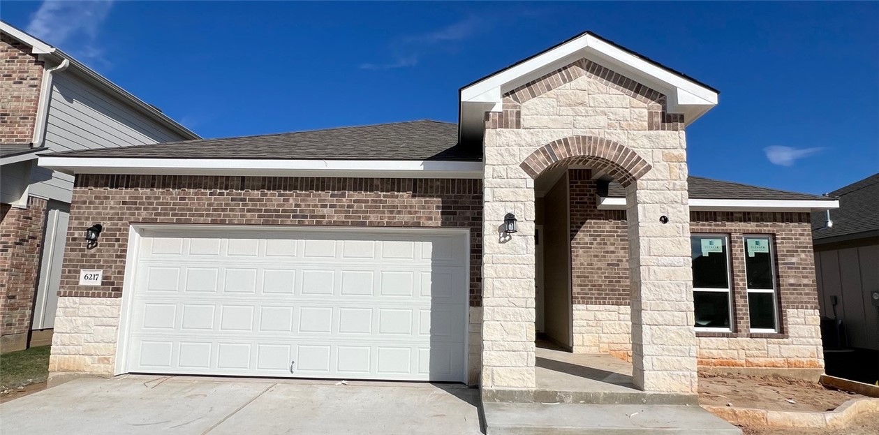 View of front facade featuring a garage