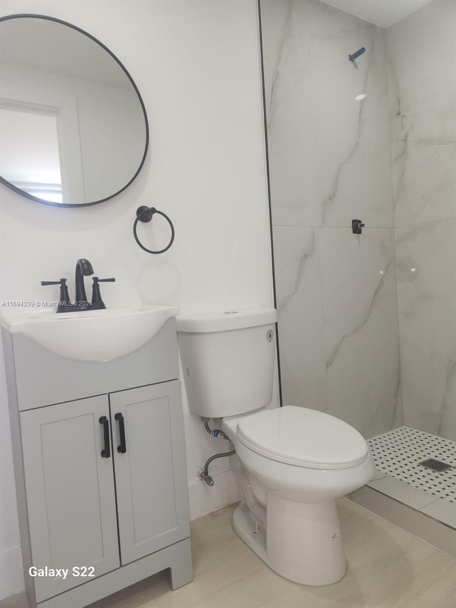 a white toilet sitting next to a bathroom sink