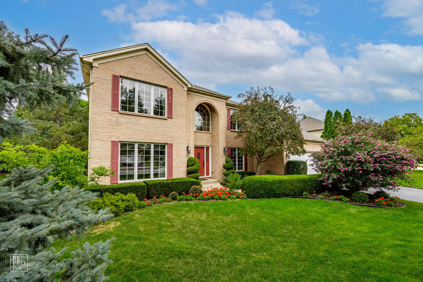 a front view of a house with garden