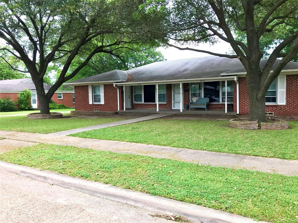 a view of a house with a yard and large trees