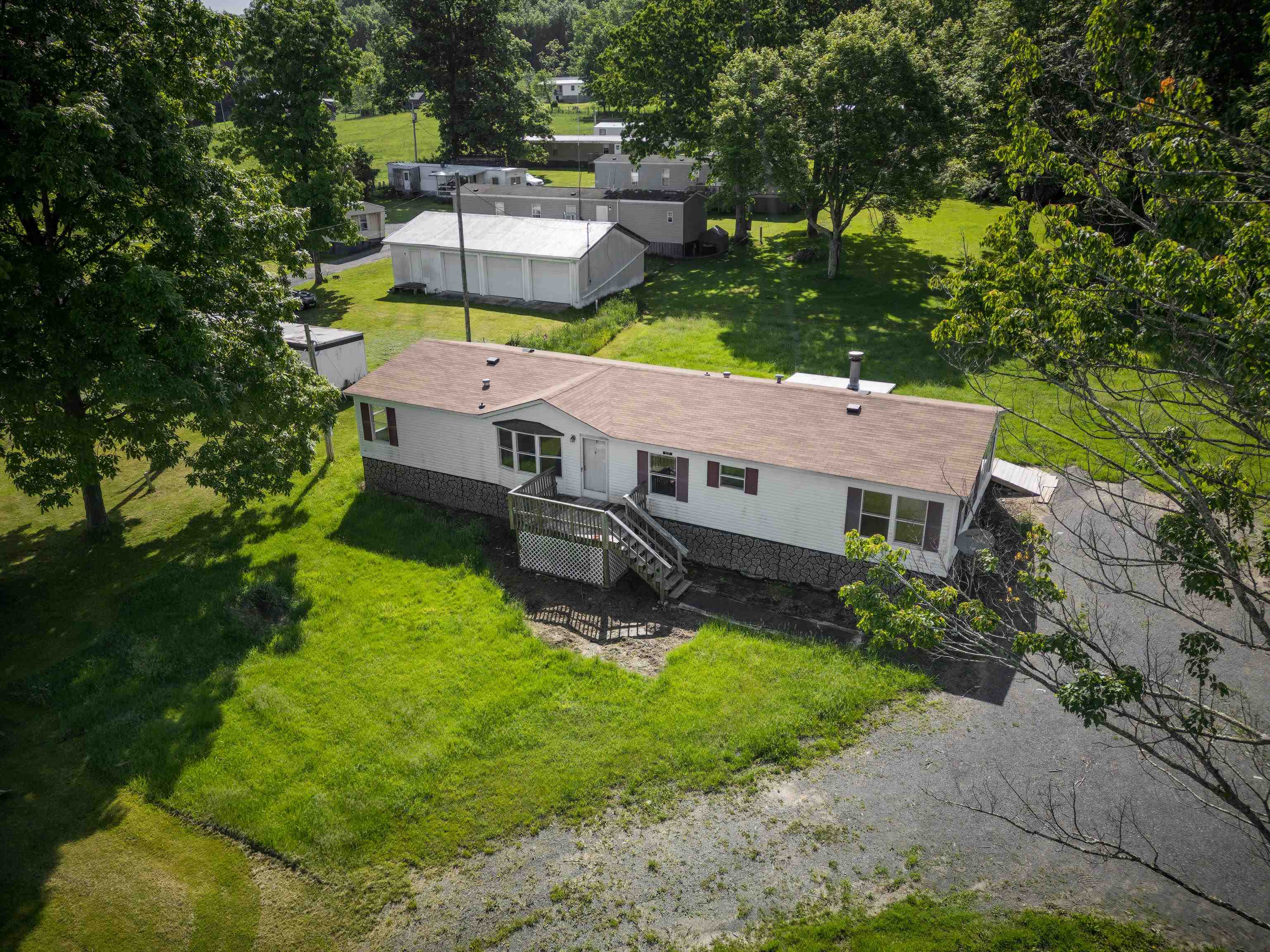 an aerial view of a house with swimming pool and a yard