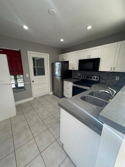 a kitchen with stainless steel appliances a refrigerator sink and microwave