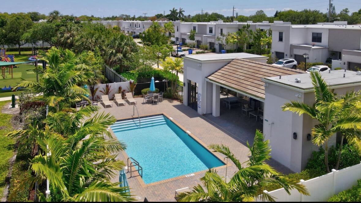 an aerial view of a house with outdoor space patio and trees all around