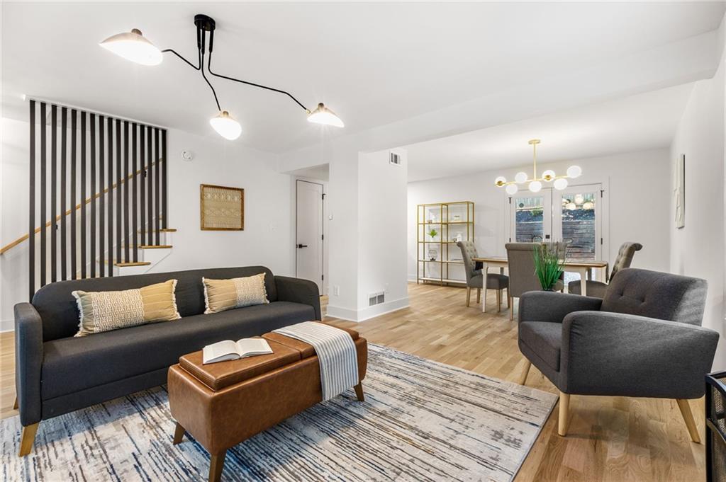 a living room with furniture and a wooden floor