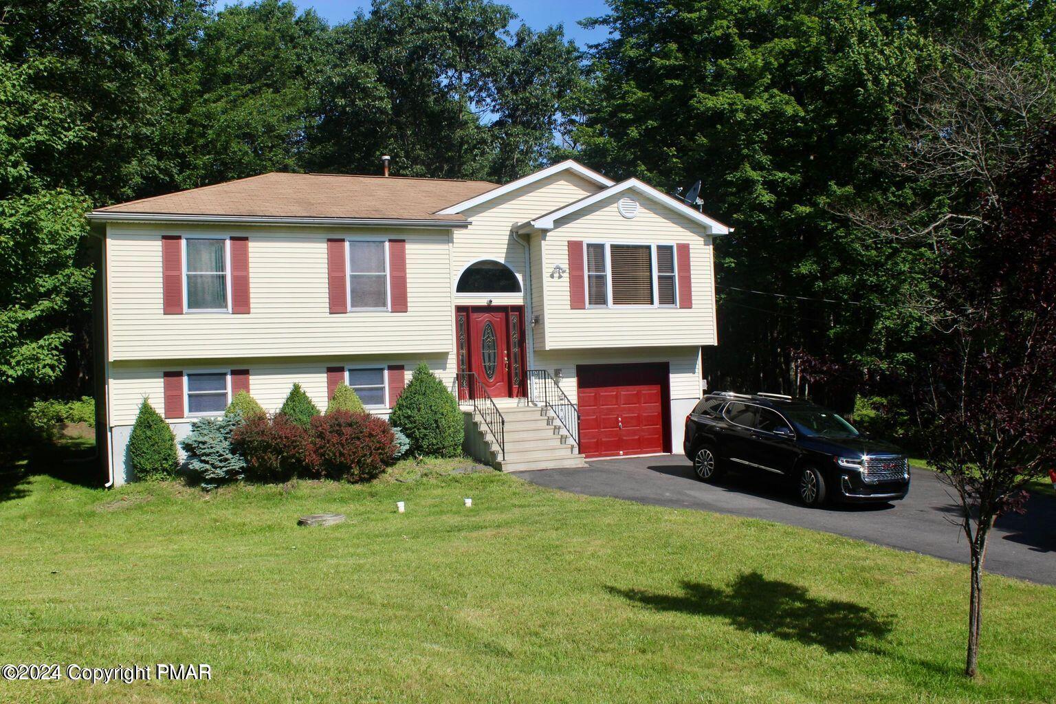 a front view of a house with a yard and garage