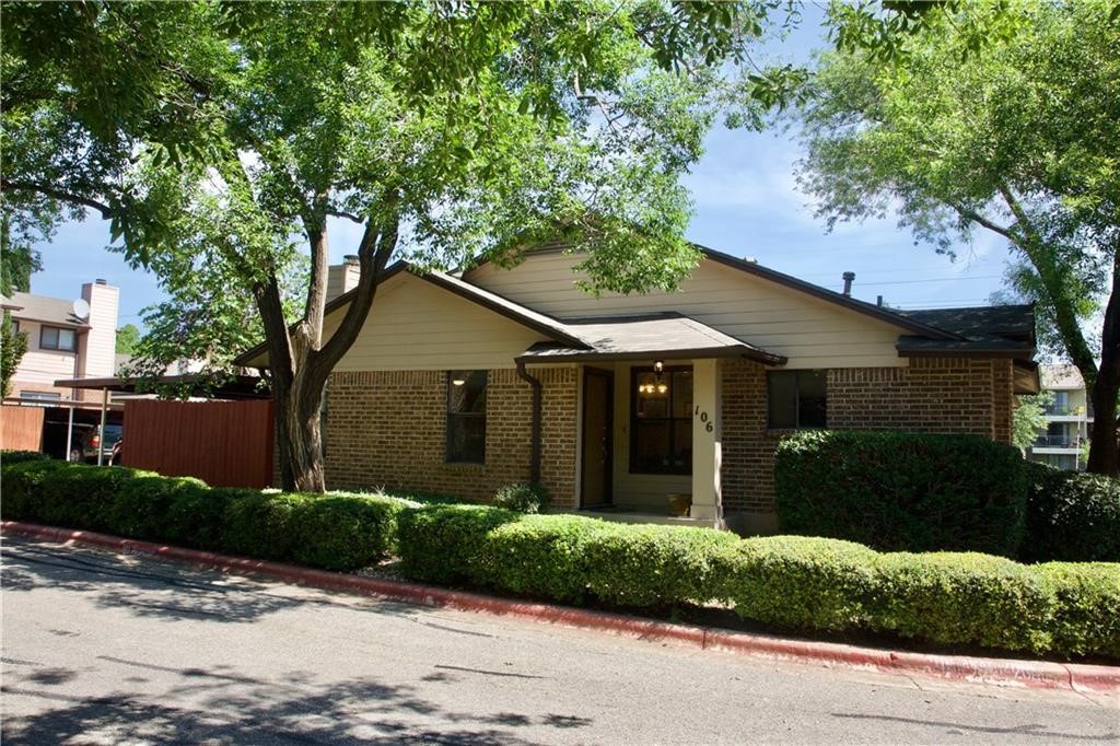 a front view of house with a garden