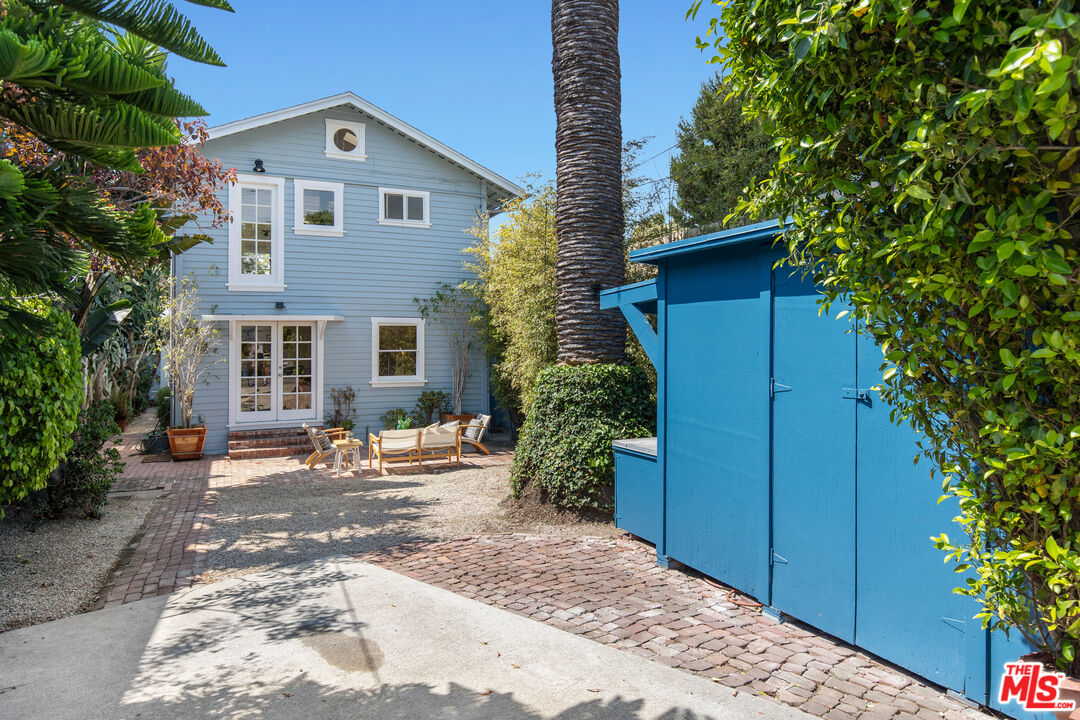 a backyard of a house with yard and outdoor seating