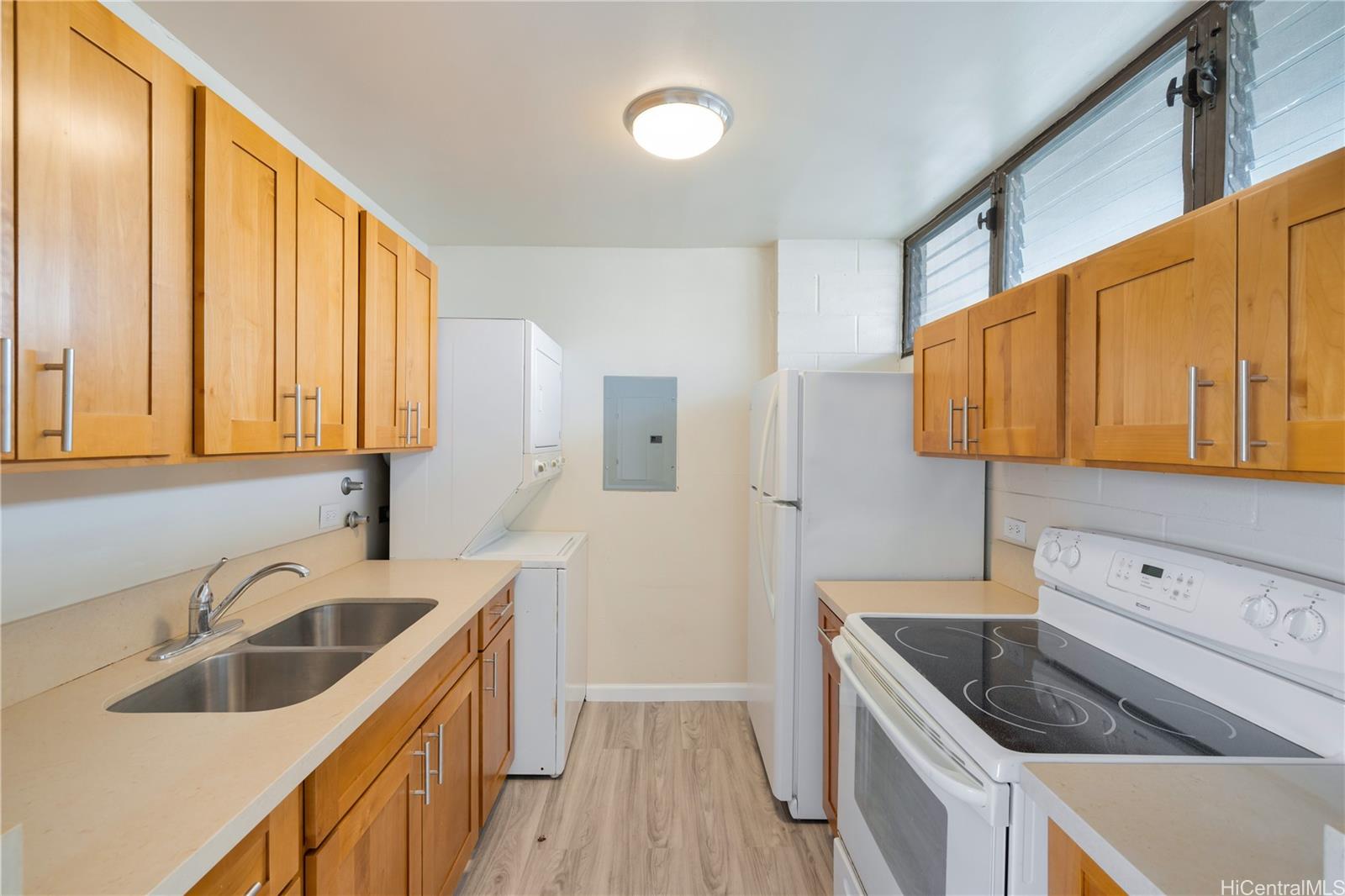 a kitchen with a sink a stove and cabinets