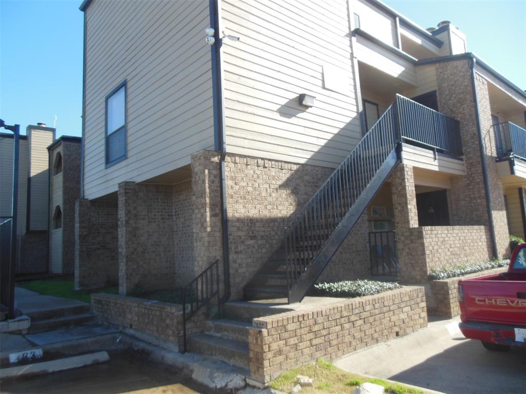 a brick house with a bench in front of it